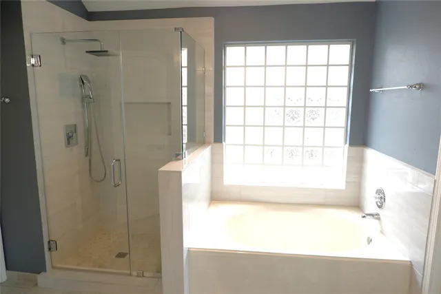 a bathroom with a bathtub and shower