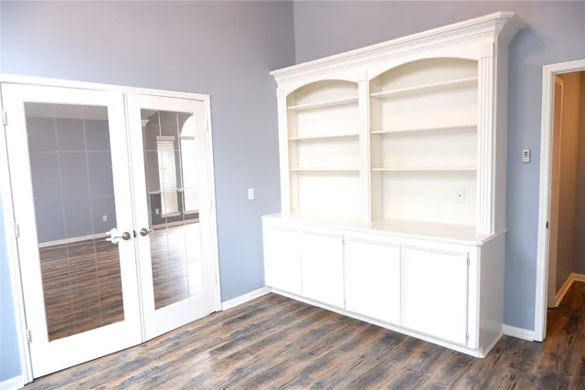 a view of a room with wooden floor and white walls