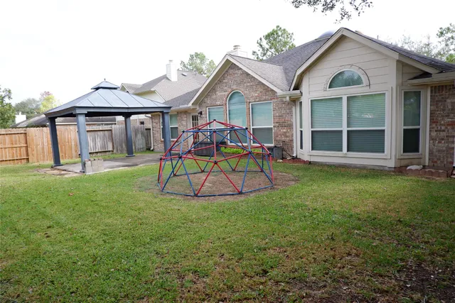 a view of a house with a yard patio and a garden