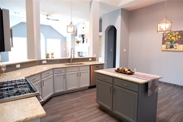 a kitchen with a sink stove and cabinets