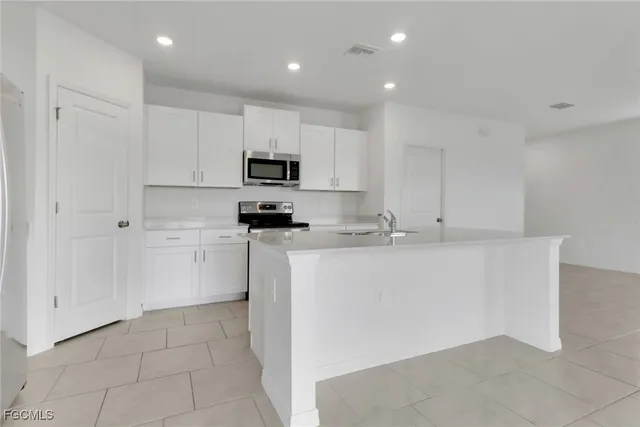 a kitchen with cabinets and white appliances