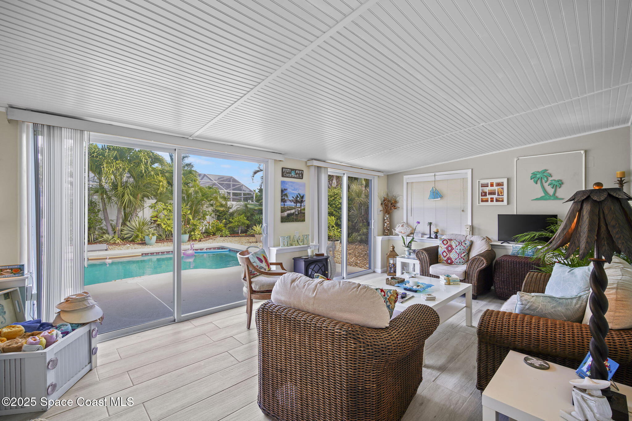 663 Bermuda Road Cocoa Beach, FL 32931 - Photo 13 of 51 a living room with furniture and a floor to ceiling window