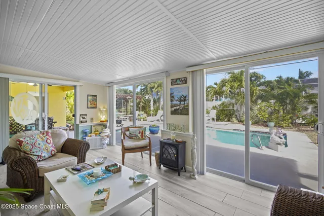 a living room with furniture and large windows