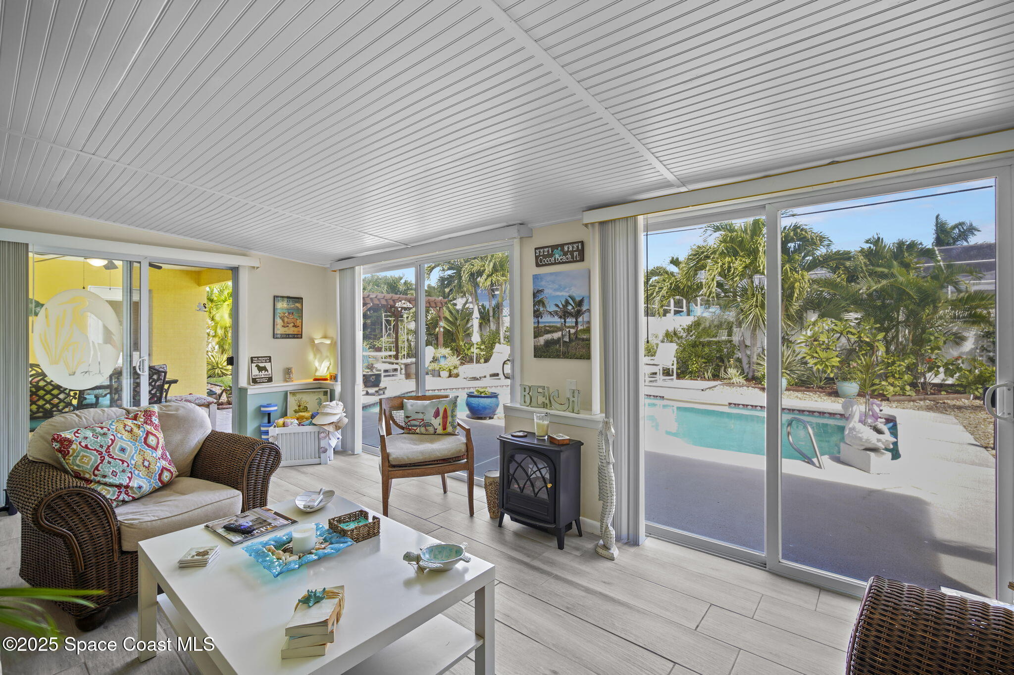 663 Bermuda Road Cocoa Beach, FL 32931 - Photo 14 of 51 a living room with furniture and large windows