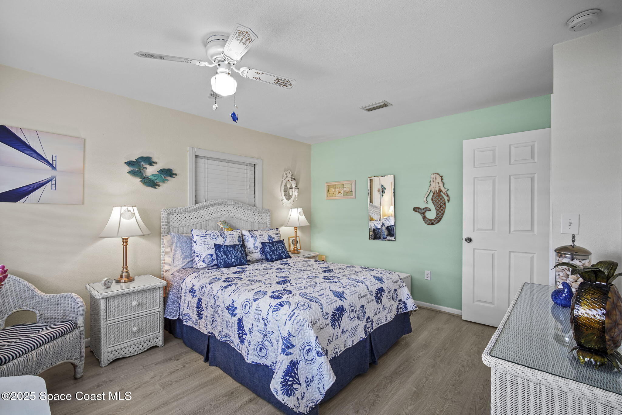 663 Bermuda Road Cocoa Beach, FL 32931 - Photo 22 of 51 a bedroom with a bed and a chandelier
