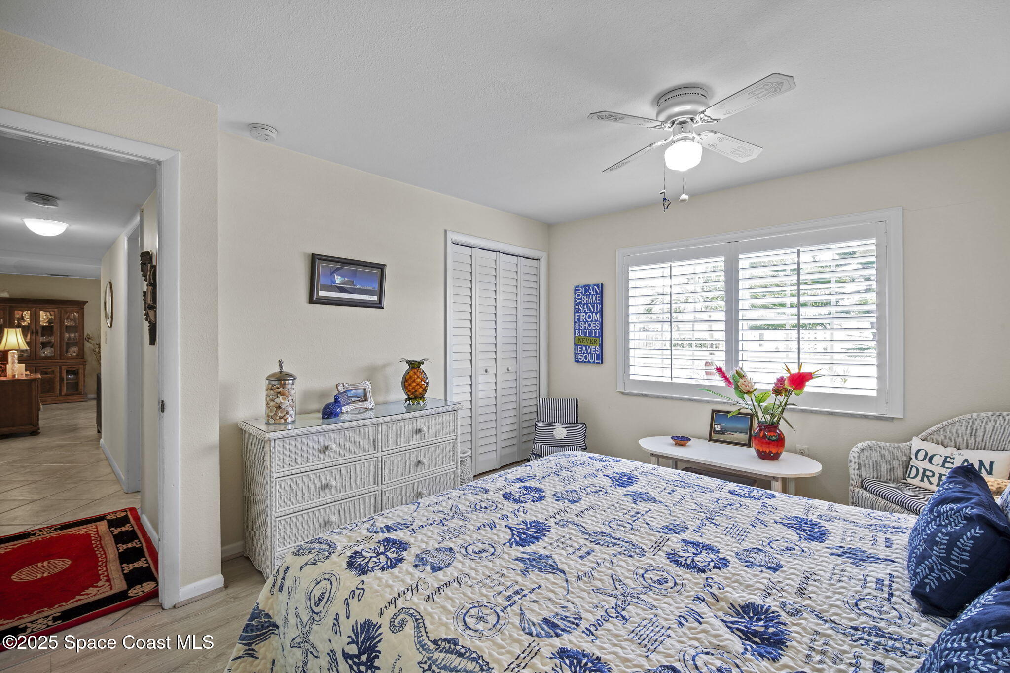 663 Bermuda Road Cocoa Beach, FL 32931 - Photo 23 of 51 a bedroom with a bed and a chandelier