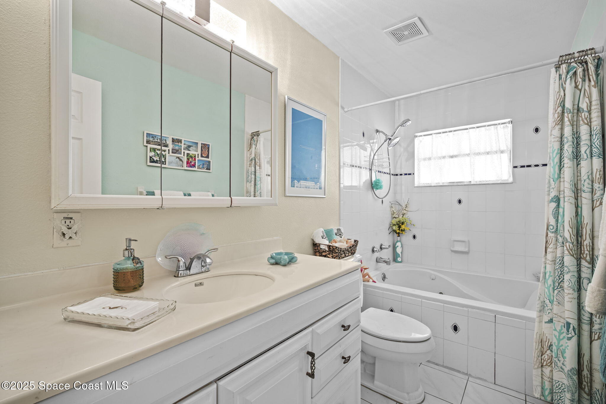 663 Bermuda Road Cocoa Beach, FL 32931 - Photo 24 of 51 a bathroom with a sink a toilet and shower