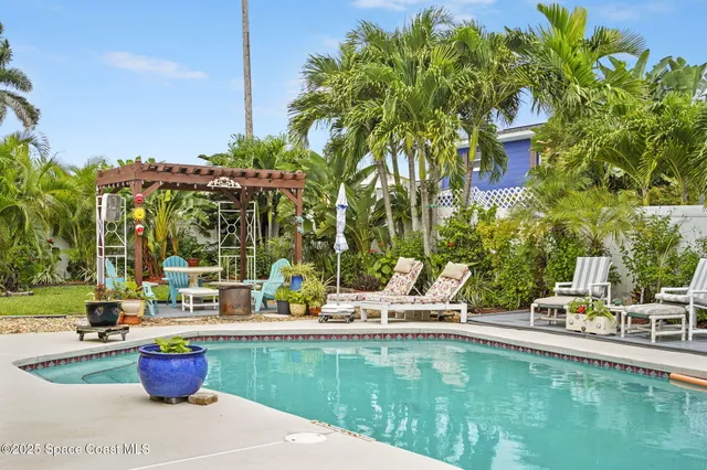 a view of swimming pool with chairs and tables