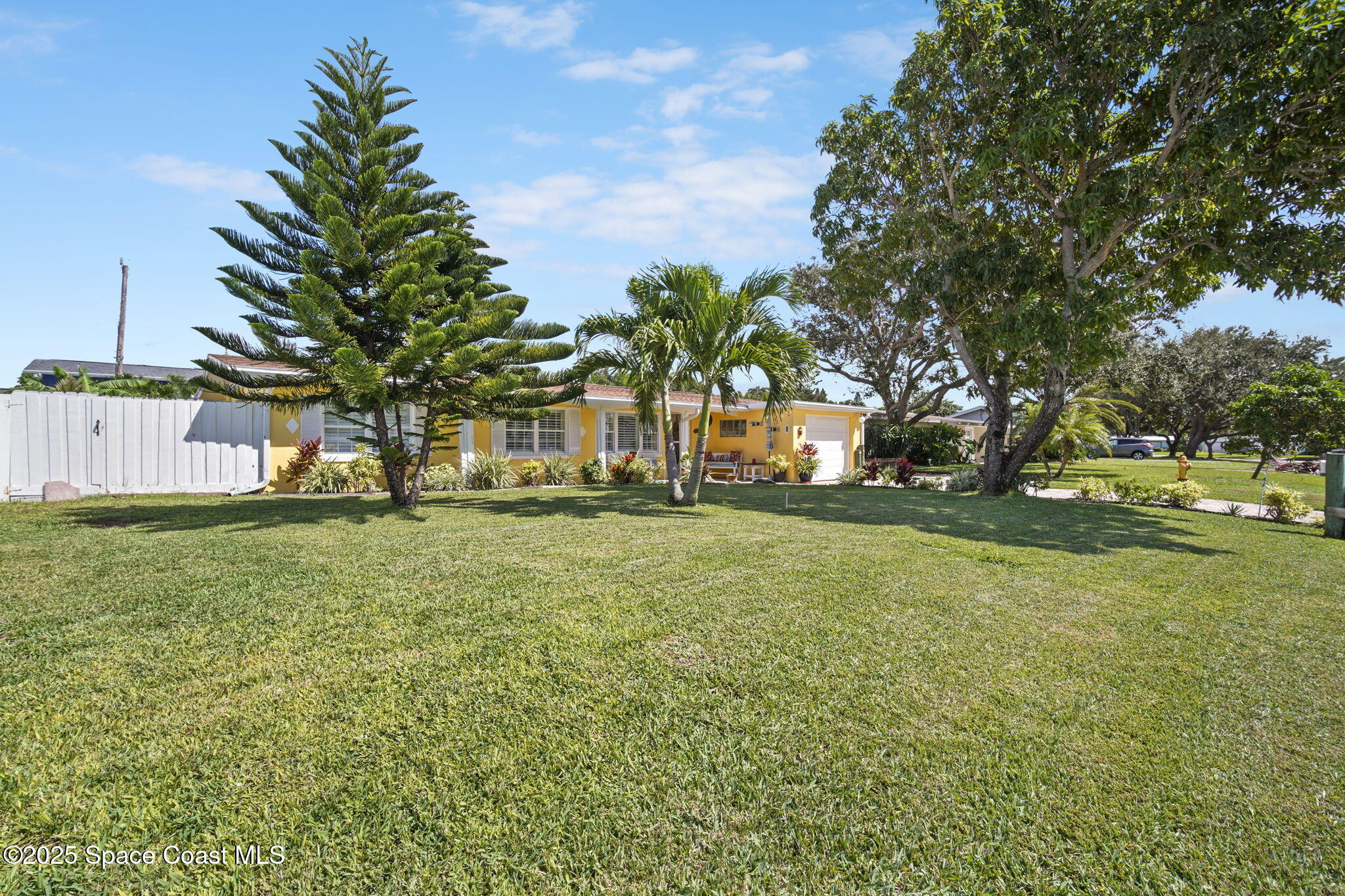 663 Bermuda Road Cocoa Beach, FL 32931 - Photo 40 of 51 a view of a house with a yard