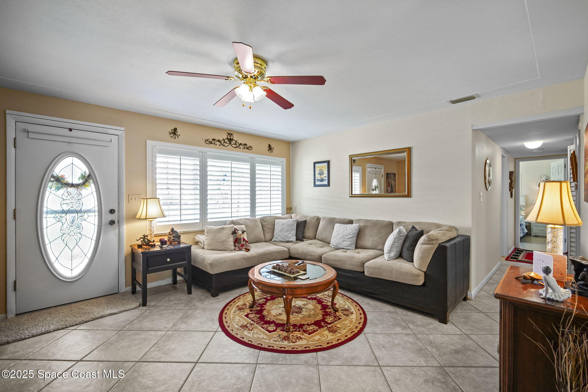 663 Bermuda Road Cocoa Beach, FL 32931 - Photo 4 of 51 a living room with furniture a table and a large window