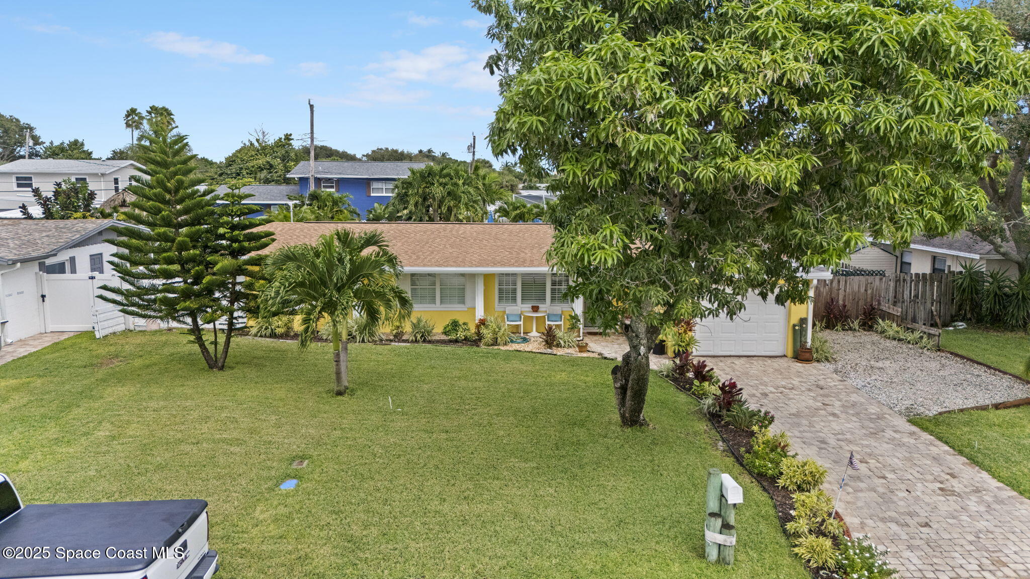 663 Bermuda Road Cocoa Beach, FL 32931 - Photo 41 of 51 a front view of a house with a yard