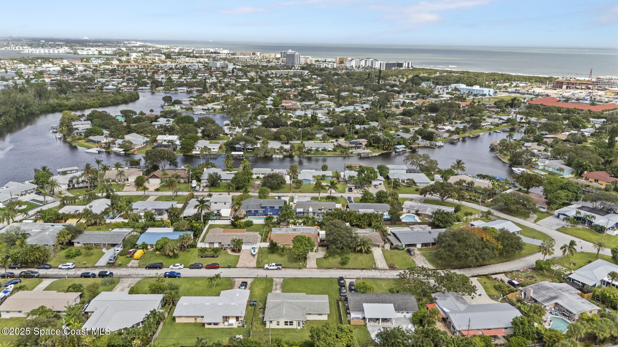 663 Bermuda Road Cocoa Beach, FL 32931 - Photo 47 of 51 an aerial view of residential building with parking space