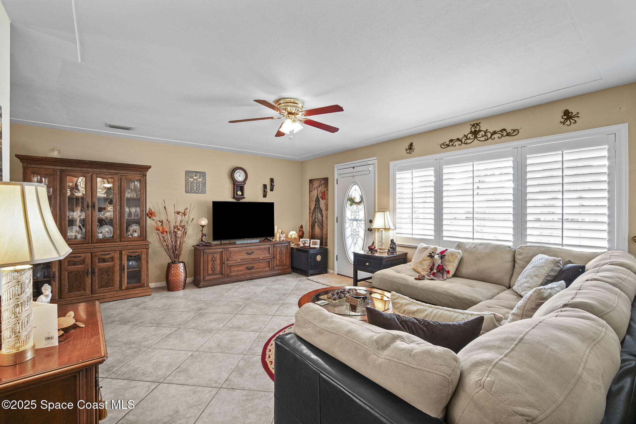 663 Bermuda Road Cocoa Beach, FL 32931 - Photo 6 of 51 a living room with furniture and a flat screen tv