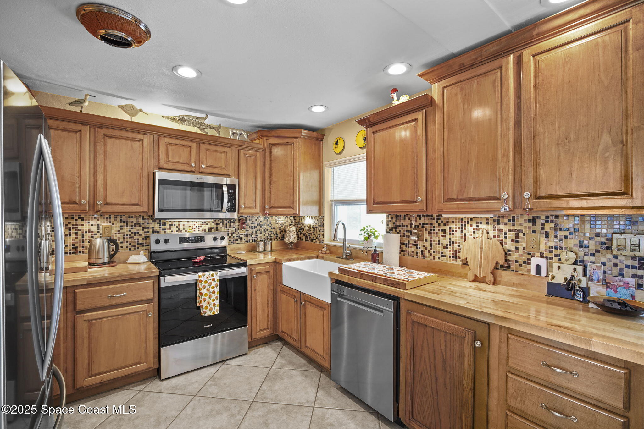 663 Bermuda Road Cocoa Beach, FL 32931 - Photo 7 of 51 a kitchen with granite countertop a sink stainless steel appliances and cabinets
