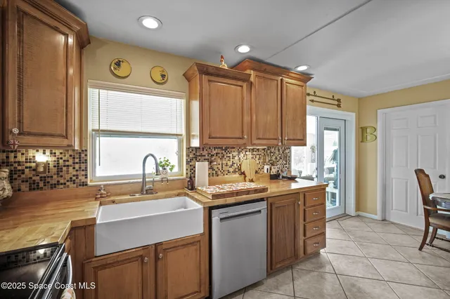 a kitchen with a sink and chairs