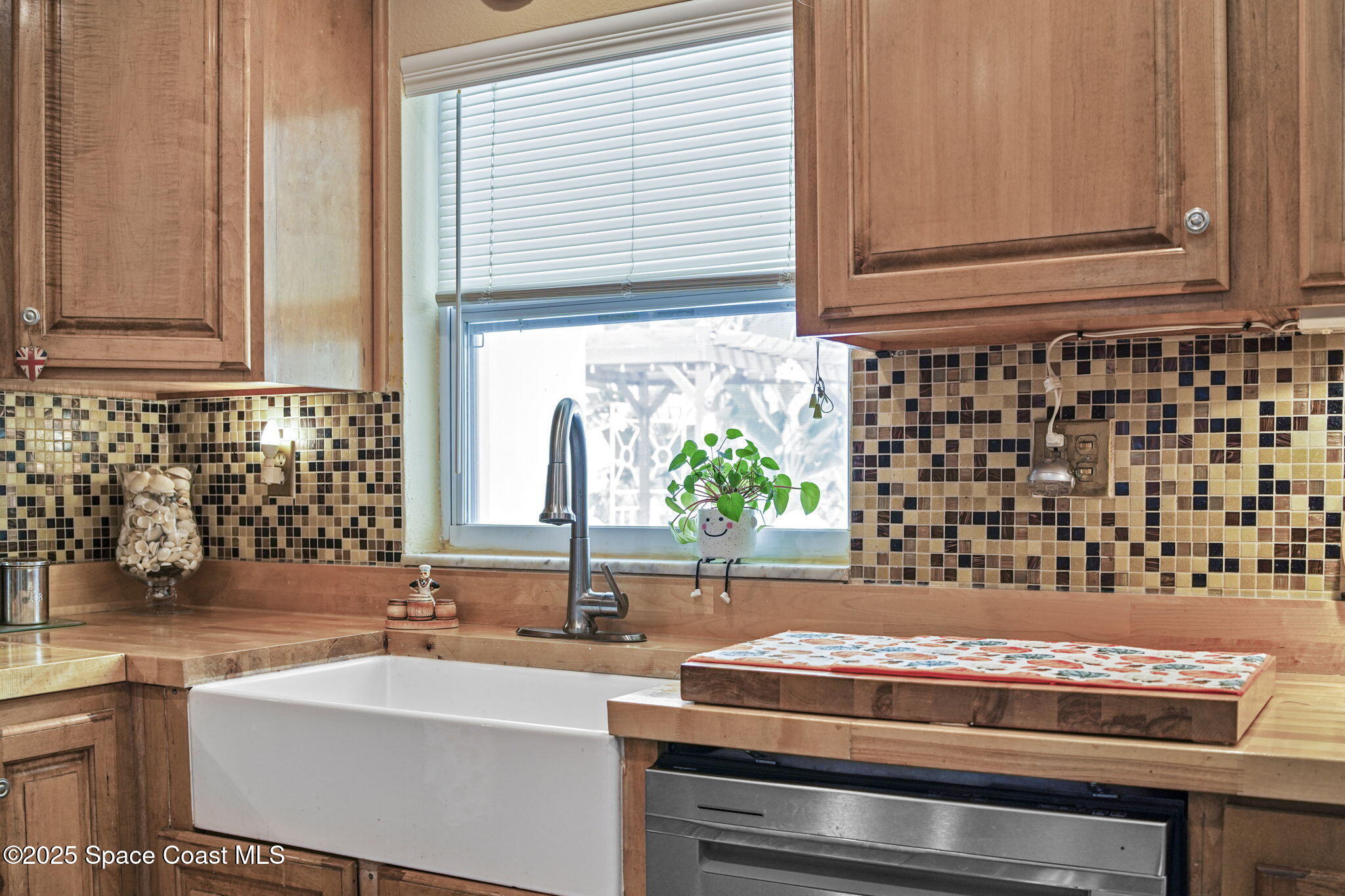 663 Bermuda Road Cocoa Beach, FL 32931 - Photo 9 of 51 a kitchen with a sink and a window