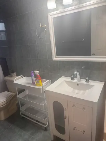 a bathroom with a sink toilet and a mirror