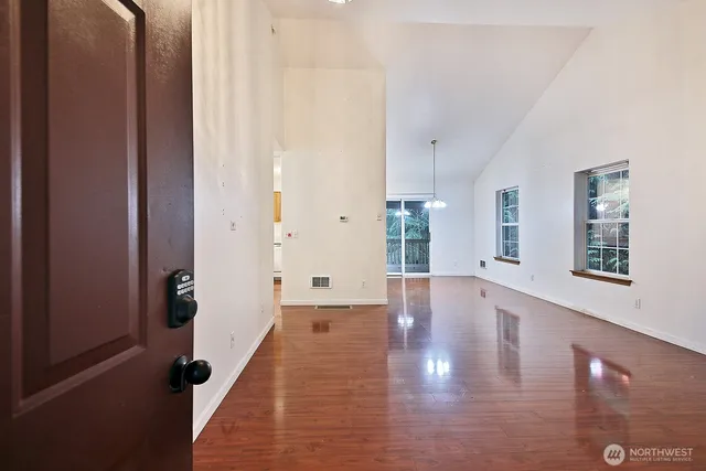 a view of an entryway with wooden floor