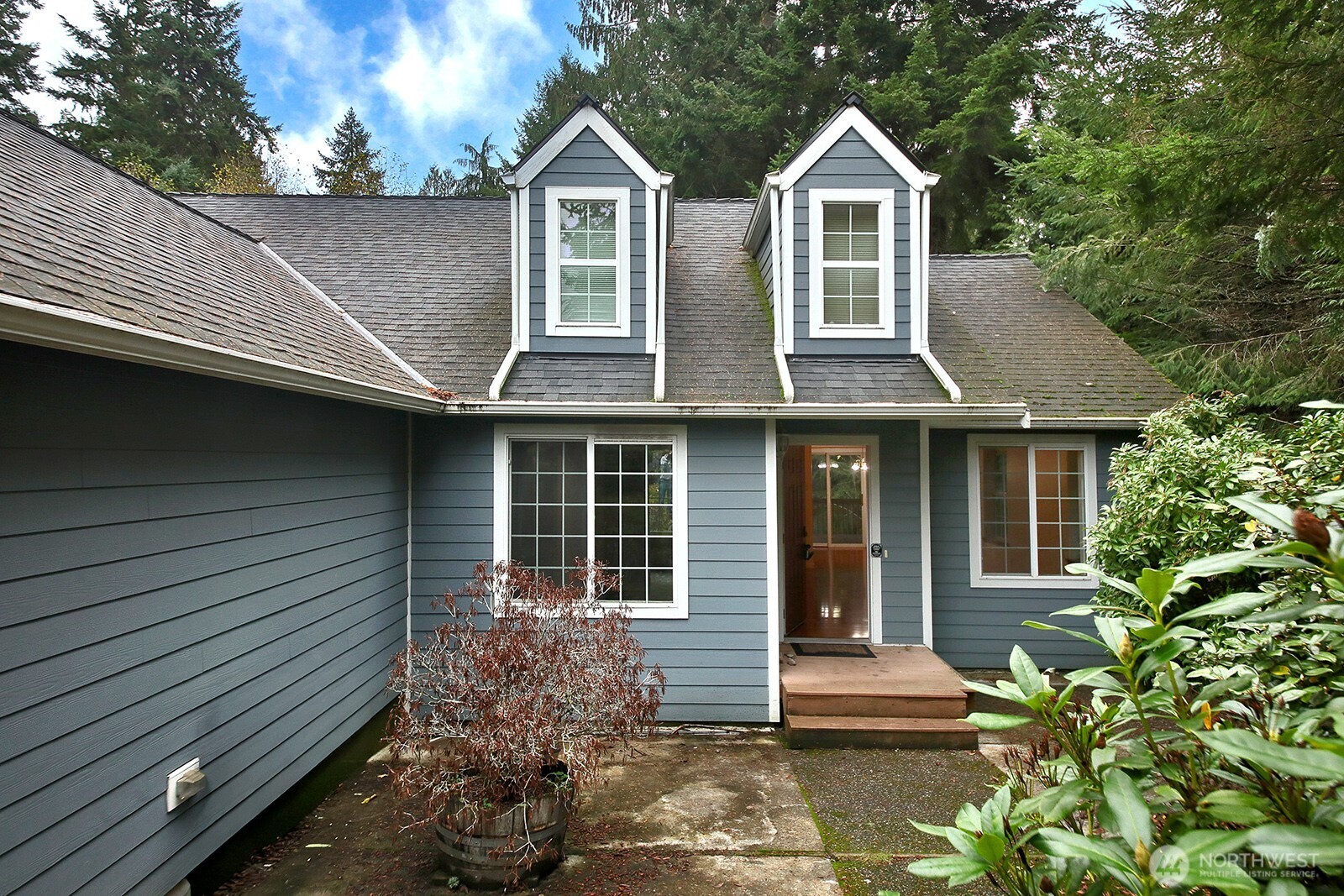 4369 Shadowood Drive Clinton, WA 98236 - Photo 2 of 37 a front view of a house with garden