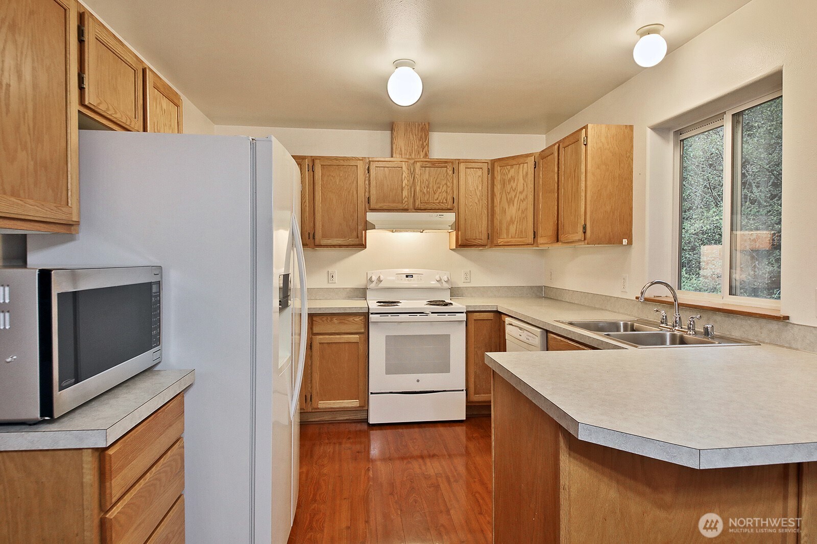 4369 Shadowood Drive Clinton, WA 98236 - Photo 24 of 37 a kitchen with a sink stove and cabinets