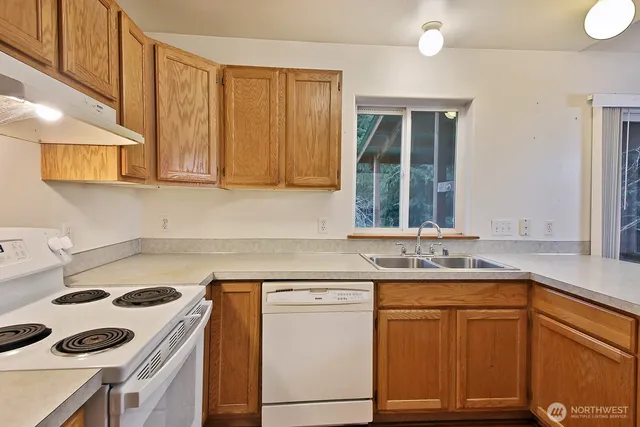 a kitchen with a sink stove and cabinets