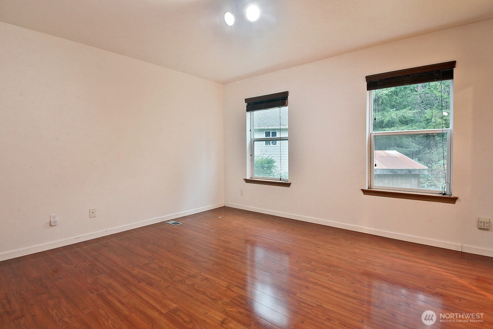 4369 Shadowood Drive Clinton, WA 98236 - Photo 32 of 37 an empty room with wooden floor and windows