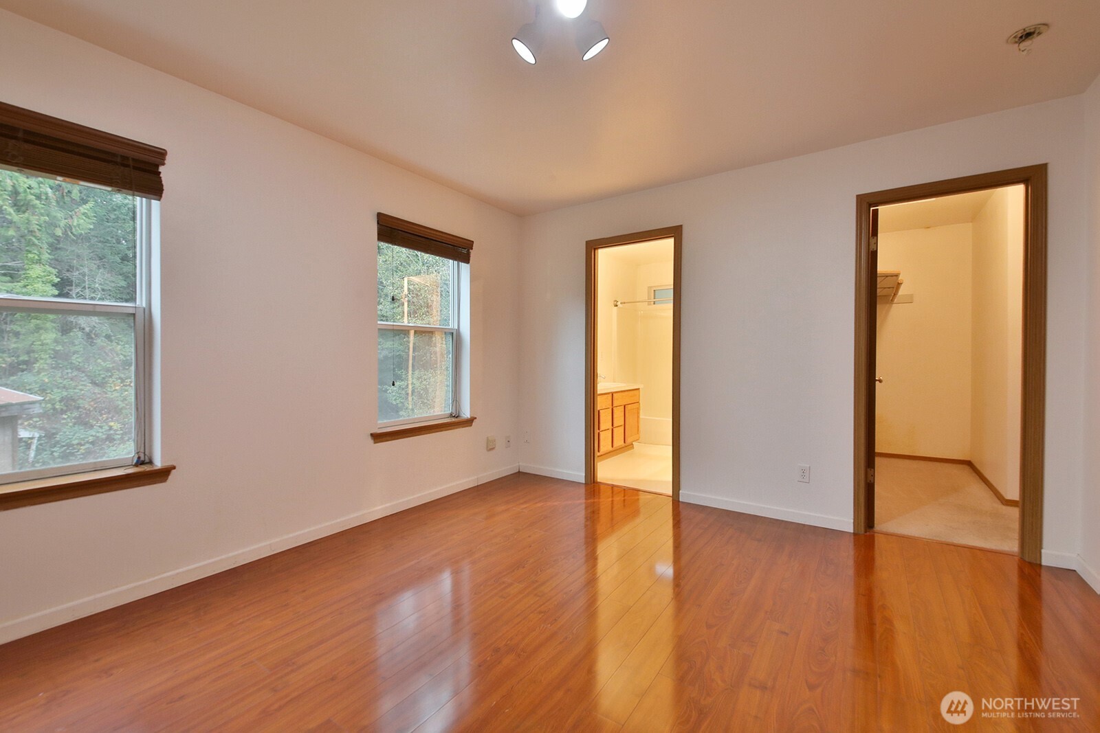 4369 Shadowood Drive Clinton, WA 98236 - Photo 35 of 37 a view of an empty room with wooden floor and a window