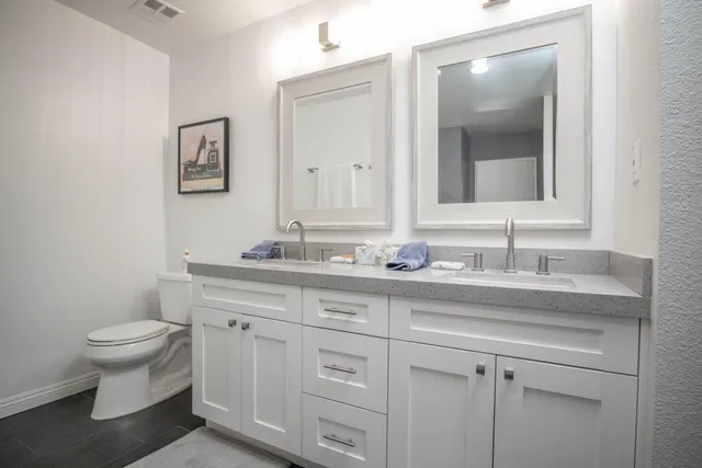 a bathroom with a toilet sink and mirror