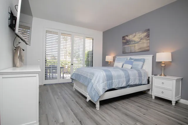 a bedroom with a large bed and a tv on table
