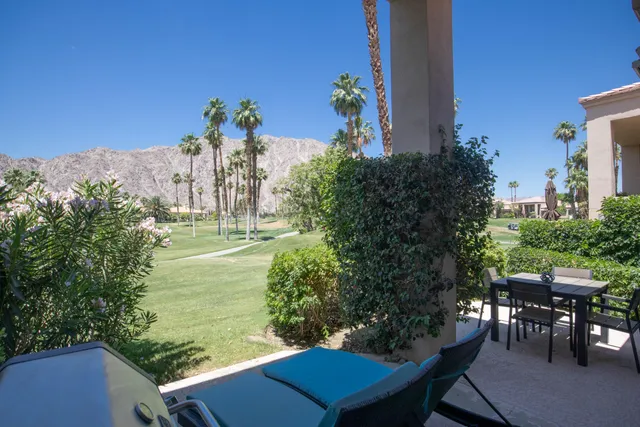 a view of a chairs and table in patio