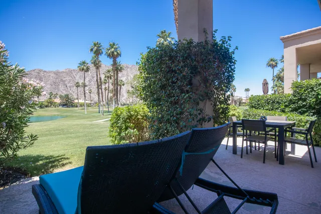 a view of a chairs and table in patio