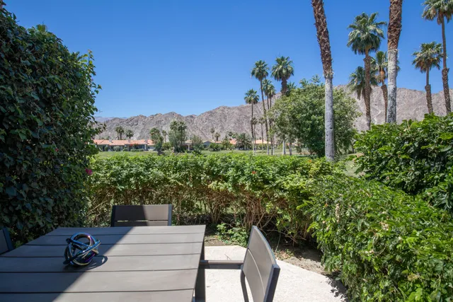 a view of a chairs and table in the patio