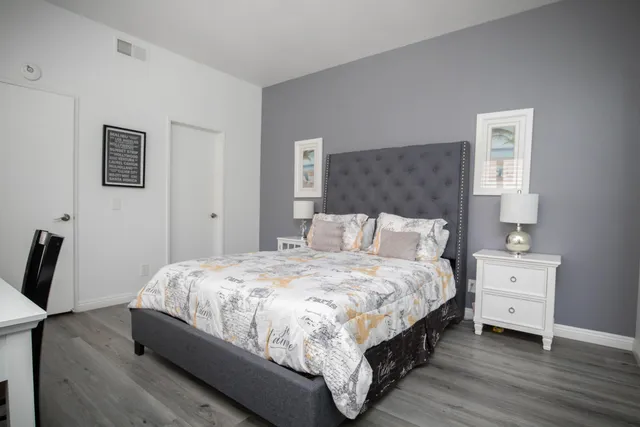 a bedroom with a bed a table and chair