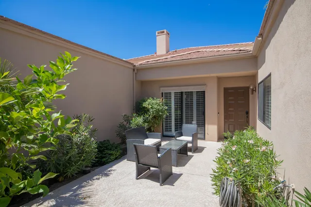 a view of a house with backyard and sitting area