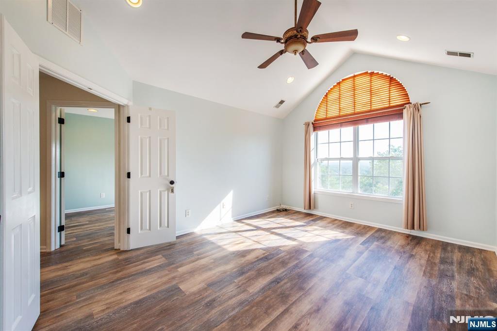 146 Summit Ridge, Unit 1406 Pompton Lakes, NJ 07442 - Photo 13 of 26 a view of empty room with wooden floor and fan