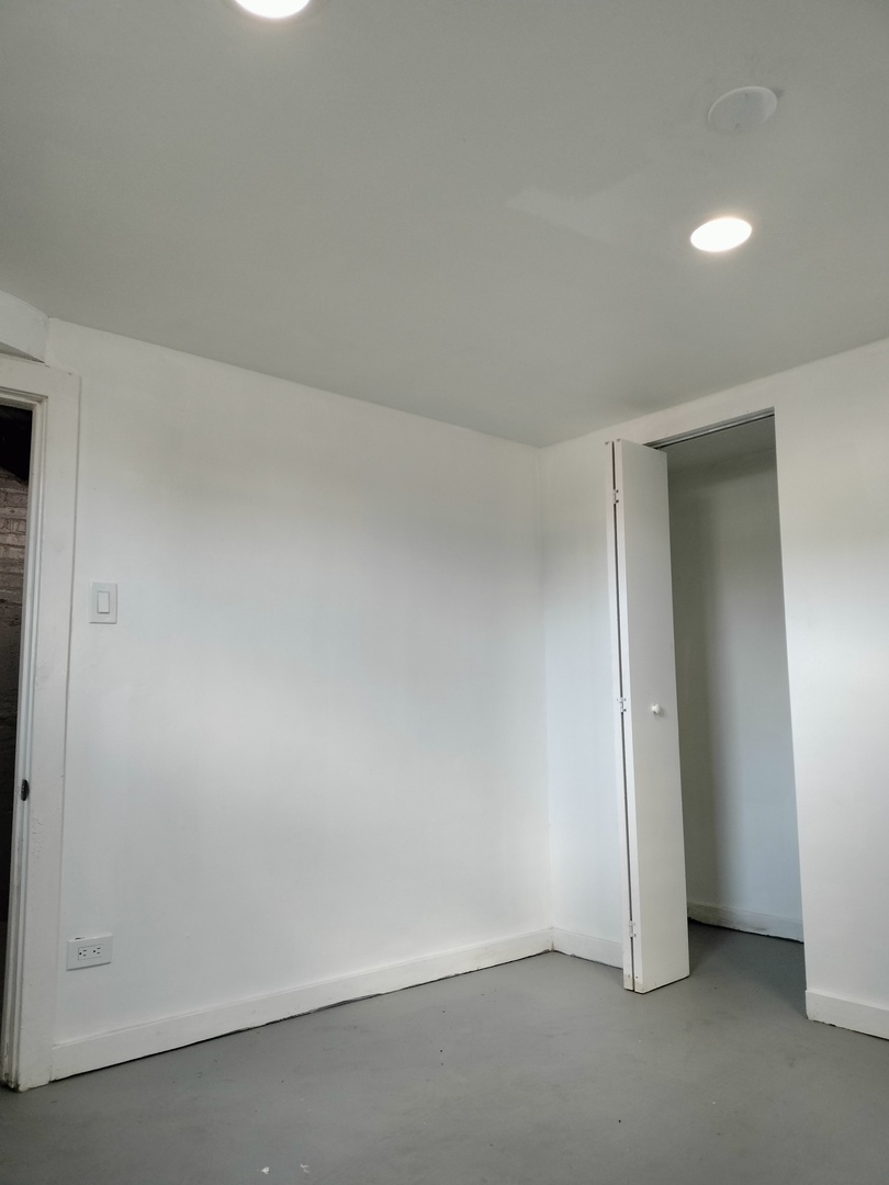 7910 South Muskegon Avenue, Unit 1 Chicago, IL 60617 - Photo 3 of 21 an empty room with a empty space