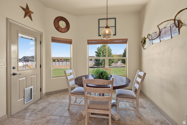 4635 East Sunny Acres Lane Moab, UT 84532 - Photo 48 of 56 Dining area featuring a circular wooden table, tile flooring, and multiple windows