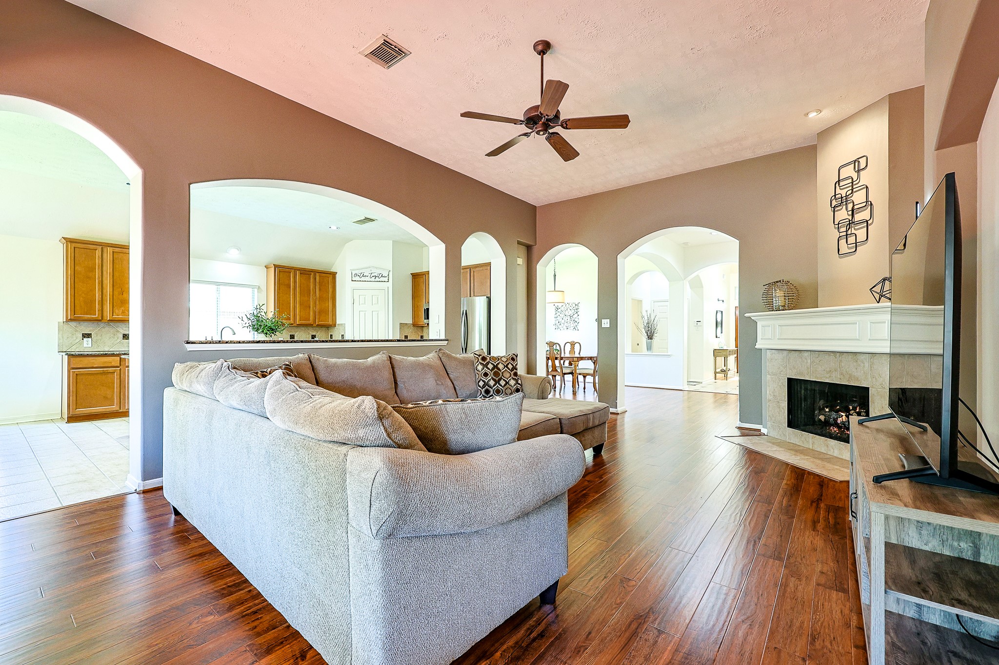 10306 Rudolph Court Missouri City, TX 77459 - Photo 13 of 34 This spacious family room acts as the ultimate gathering hub, combining architectural charm with modern comfort for effortless everyday living and entertaining.
