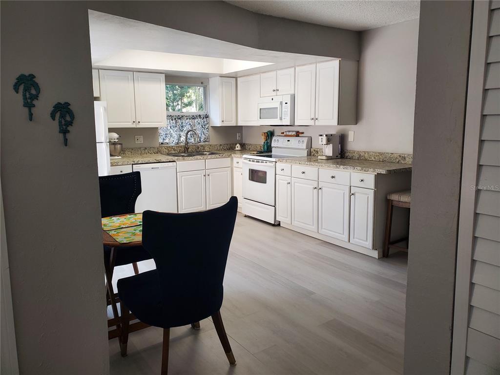 107 Springwood Square Port Orange, FL 32129 - Photo 14 of 36 a kitchen with a refrigerator cabinets and a sink