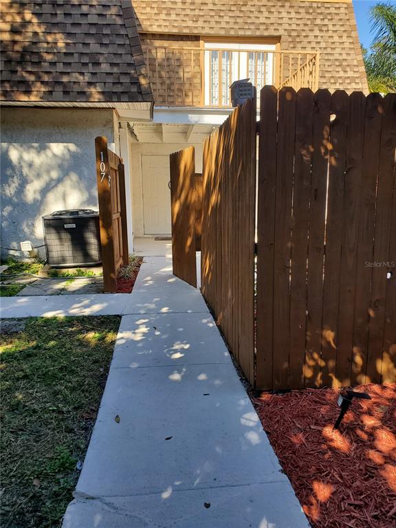 107 Springwood Square Port Orange, FL 32129 - Photo 2 of 36 a view of a pathway with a backyard