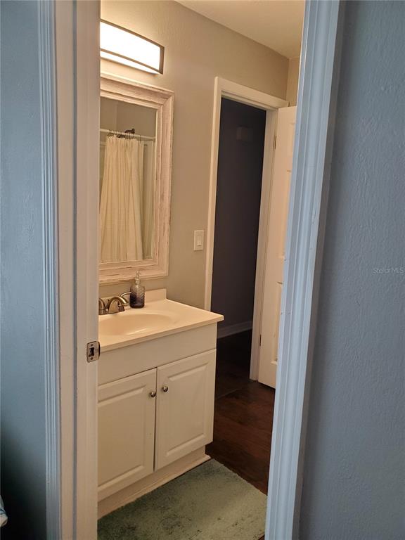 107 Springwood Square Port Orange, FL 32129 - Photo 32 of 36 a bathroom with a sink and a mirror