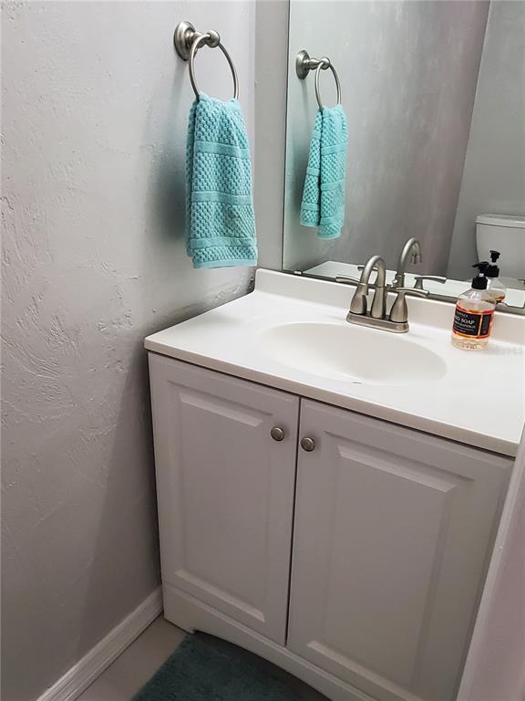 107 Springwood Square Port Orange, FL 32129 - Photo 10 of 36 a bathroom with a sink and mirror