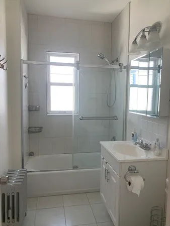 a bathroom with a sink vanity tub and shower