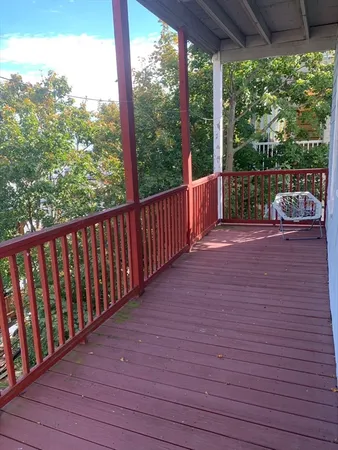 a view of a balcony with wooden floor