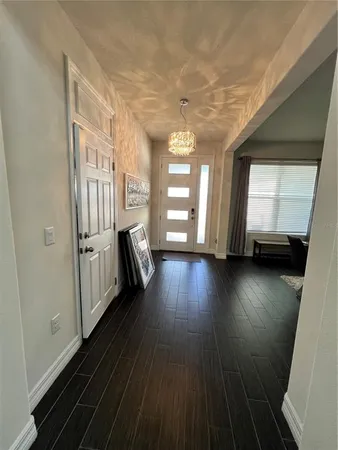 a view of a room with wooden floor and stairs