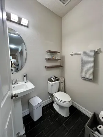 a white toilet sitting next to a bathroom sink