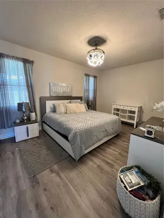 a bedroom with a bed furniture and a large window