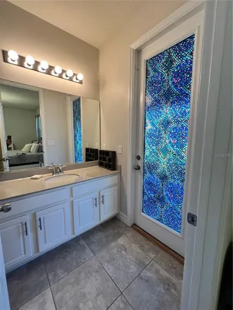 a spacious bathroom with a double vanity sink and a mirror