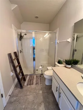 a bathroom with a sink a toilet and a shower