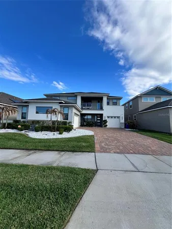a front view of a house with a garden and pathway